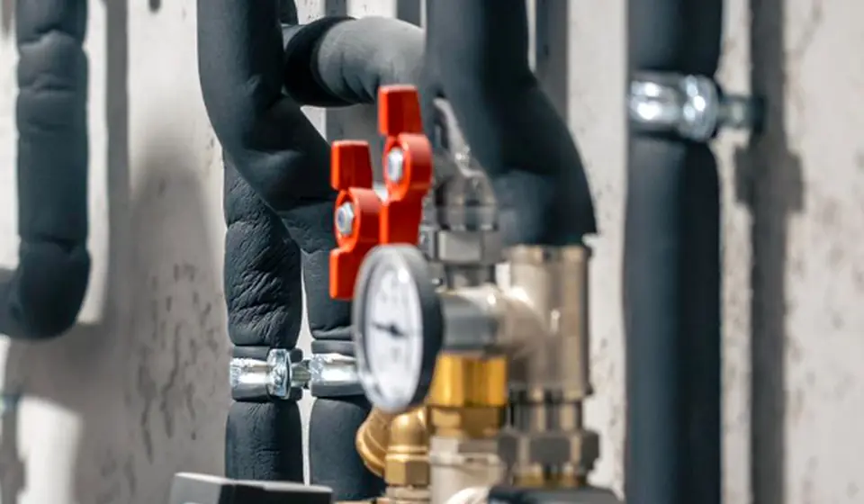 Close-up of pipes, valves, and pressure gauges